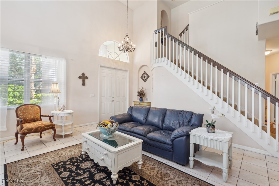 9475 Silver Pine Loop Fort Myers, FL 33967 - Photo 5 of 34 a living room with furniture ceiling fan and a rug