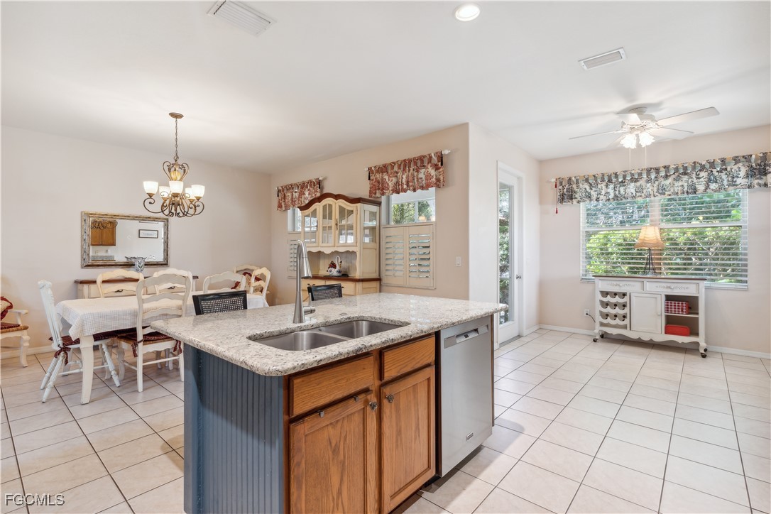 9475 Silver Pine Loop Fort Myers, FL 33967 - Photo 10 of 34 a kitchen with a counter space a sink cabinets and appliances