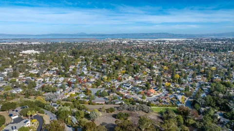 an aerial view of residential building and trees around