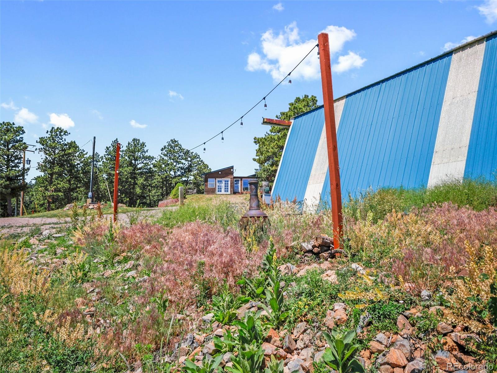 1044 South Grapevine Road Golden, CO 80401 - Photo 39 of 49 a view of a backyard with plants and a garden
