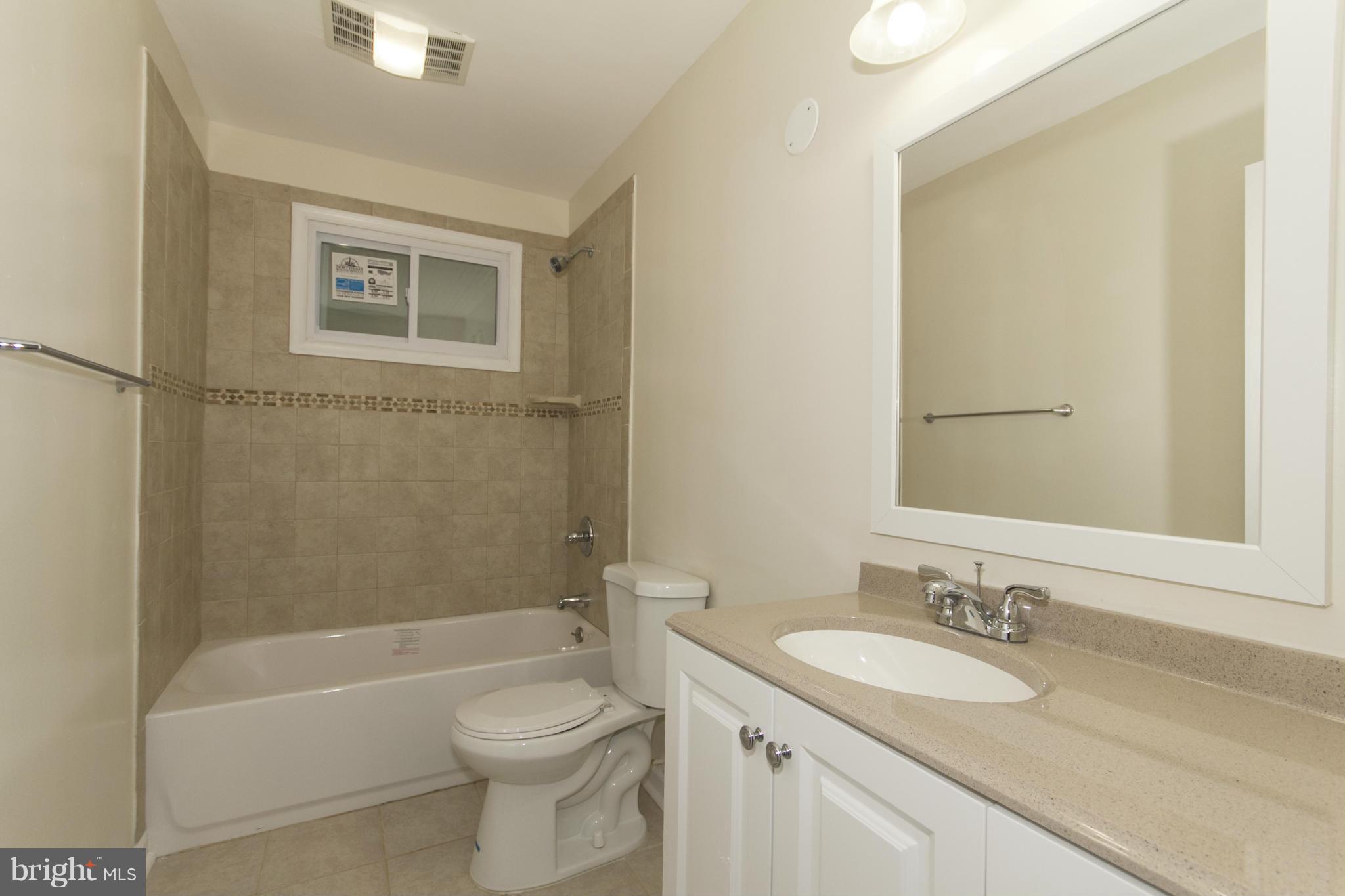 1220 Willow Road Baltimore, MD 21222 - Photo 14 of 23 a bathroom with a granite countertop sink toilet and shower