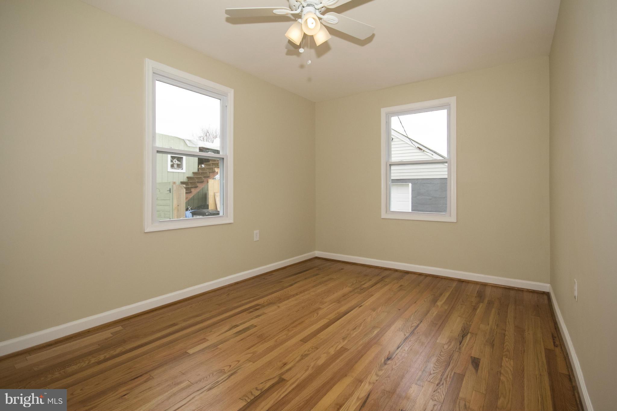 1220 Willow Road Baltimore, MD 21222 - Photo 16 of 23 a view of an empty room with wooden floor and a window