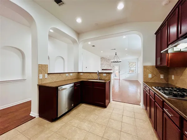 a kitchen with stainless steel appliances granite countertop a stove and a refrigerator