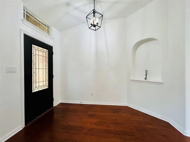 a view of an entryway with wooden floor