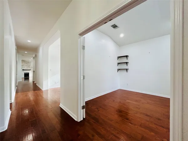 a view of a hallway with wooden floor