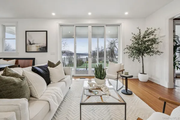a living room with furniture and a large window with outer view