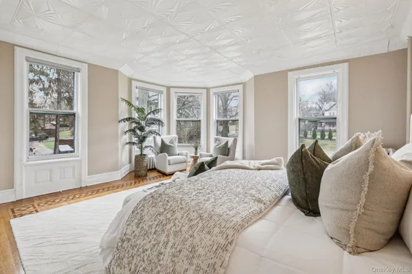 a living room with furniture and large windows