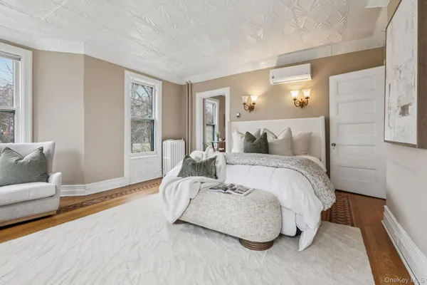 a spacious bedroom with a bed and a couch