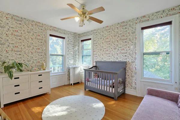 a view of a bedroom with furniture and windows