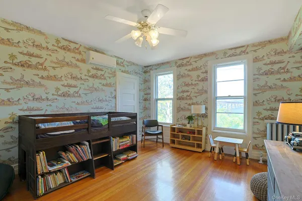a living room with furniture and a book shelf