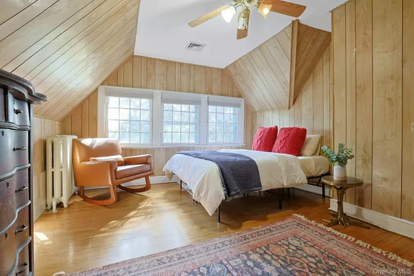 a bed room with a bed and a chair