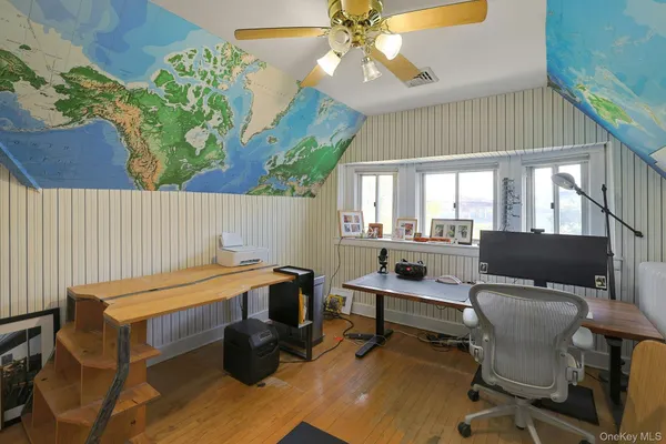 a view of a workspace with furniture and a window
