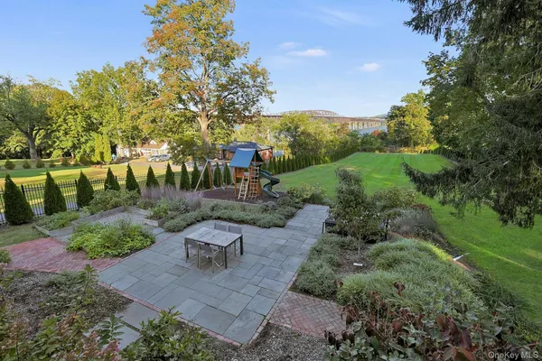 a view of a garden with plants and a bench