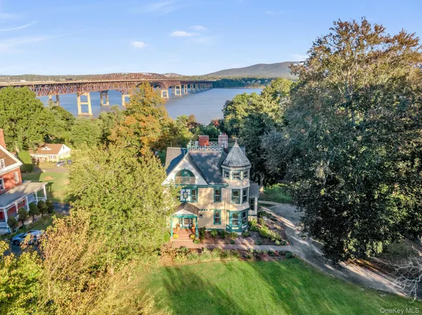 a view of a house with a yard and lake view