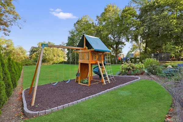 a view of outdoor space with playground and green space