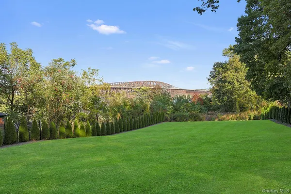 a view of a grassy field with trees in the background