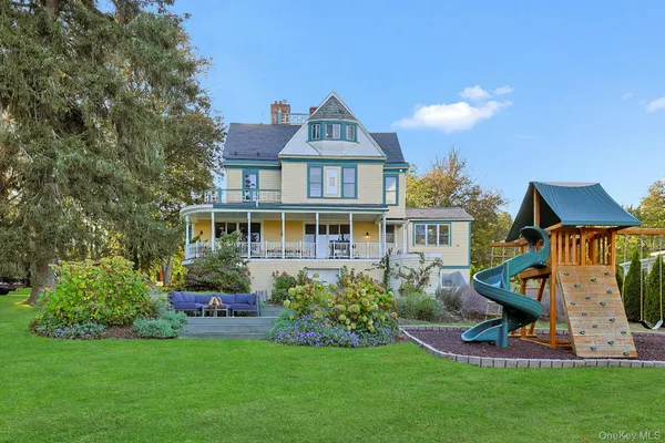 a front view of a house with a garden and plants
