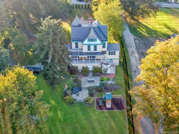 a view of a big yard with plants and large trees