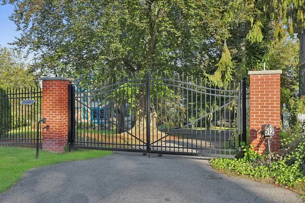 a view of a yard with wooden fence