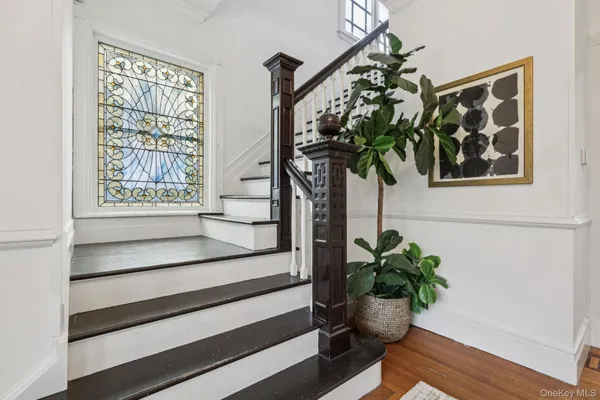 a vase of flowers sitting on a table in a window