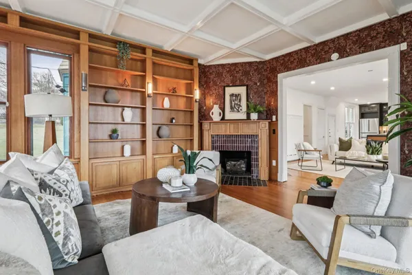 a living room with furniture a fireplace and a large window