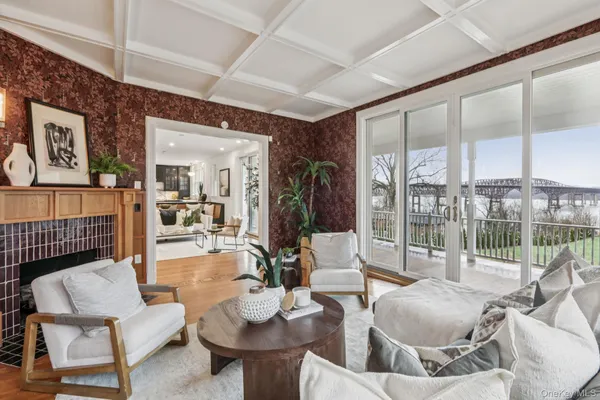 a living room with furniture and a floor to ceiling window