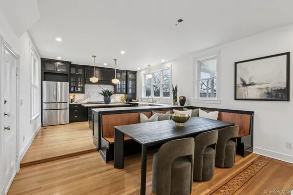 a kitchen with stainless steel appliances granite countertop a kitchen island a stove and a sink