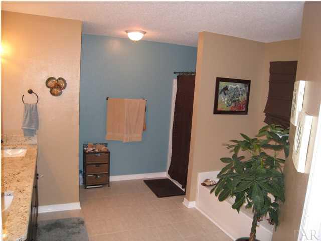 7570 Woodmont Road Navarre, FL 32566 - Photo 13 of 25 Master bath with tile floors, double vanity and separate tub/shower