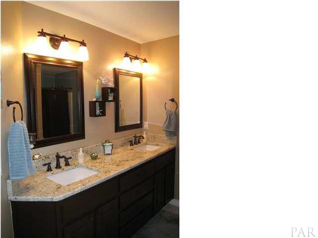 7570 Woodmont Road Navarre, FL 32566 - Photo 15 of 25 Double vanity with upgraded framed mirrors and oil rubbed bronze fixtures