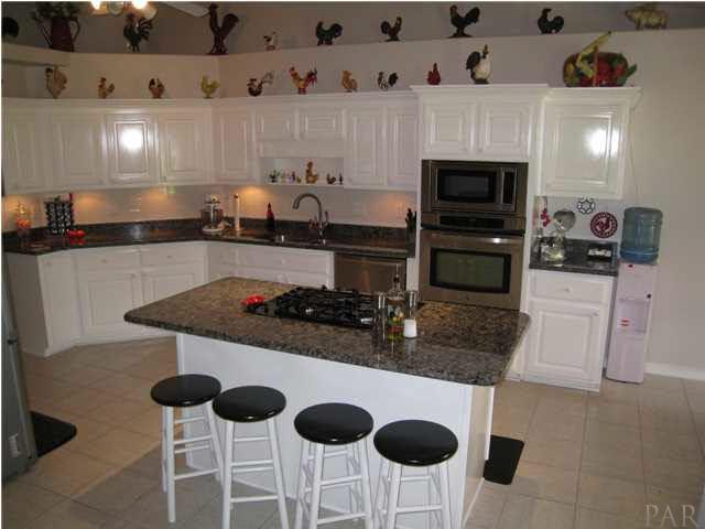 7570 Woodmont Road Navarre, FL 32566 - Photo 8 of 25 Kitchen island offers a gas range and breakfast bar