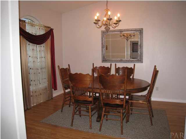 7570 Woodmont Road Navarre, FL 32566 - Photo 10 of 25 Another view of the large dining room with wood flooring