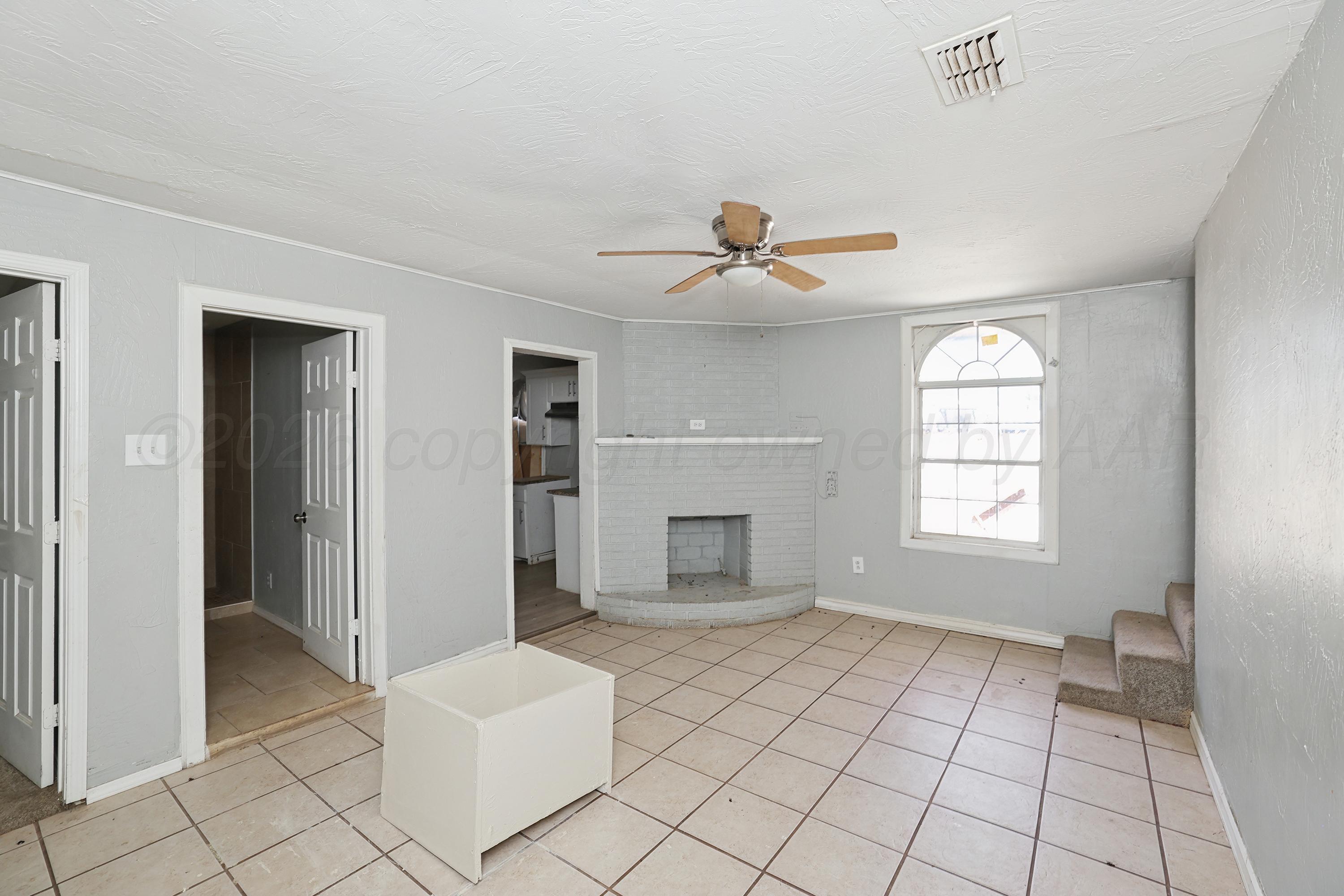 730 North Johnson Street Amarillo, TX 79107 - Photo 11 of 27 a view of an empty room with window and chandelier fan