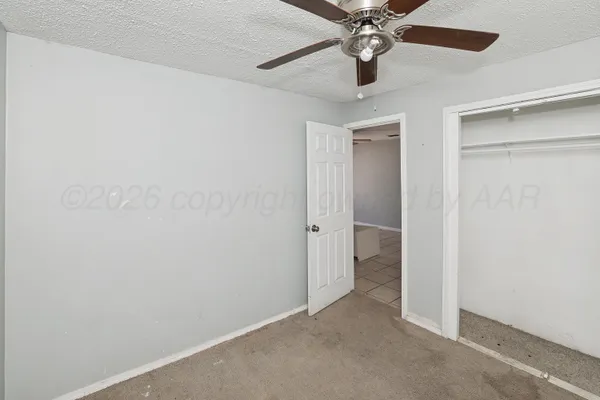 an empty room with a ceiling fan