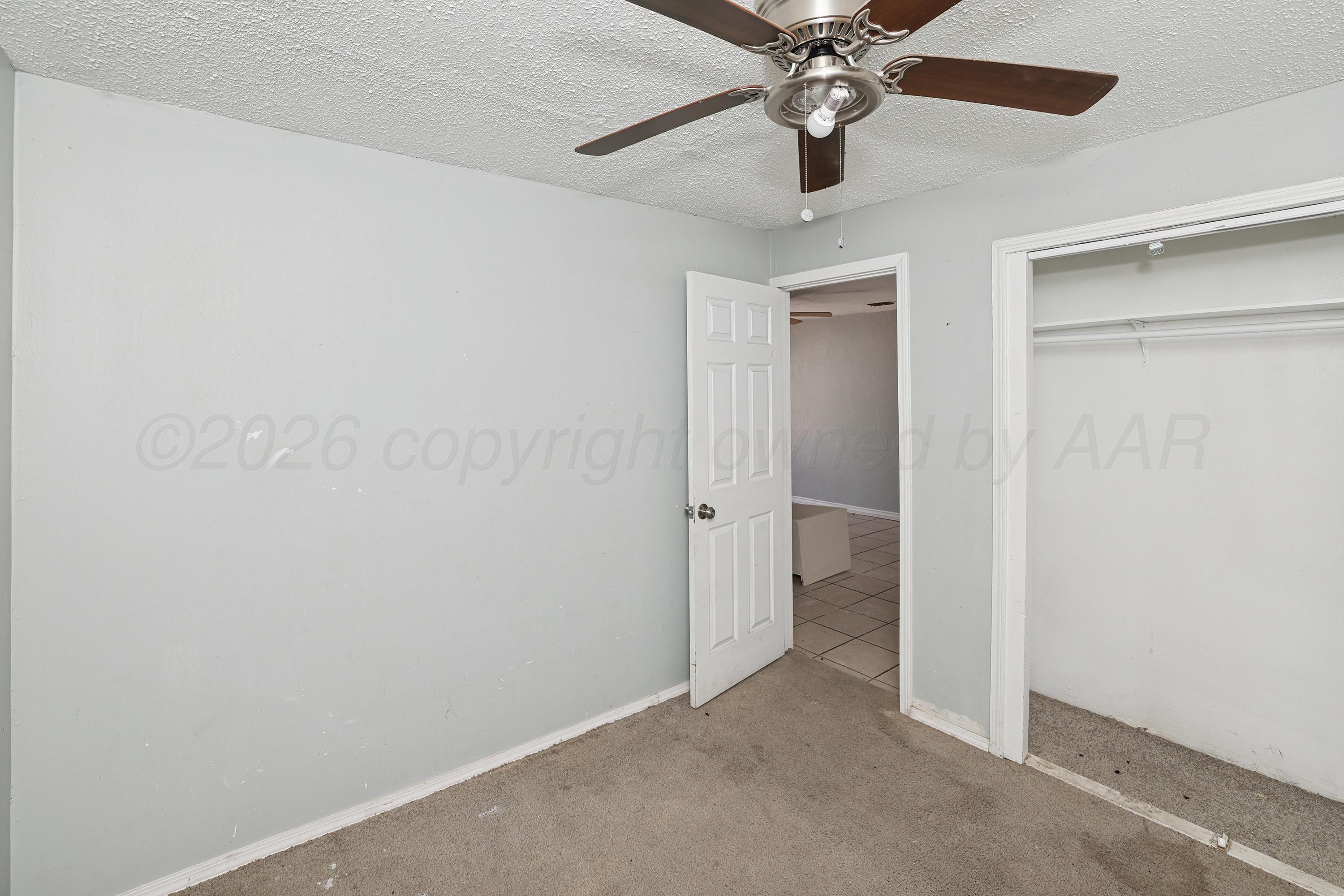730 North Johnson Street Amarillo, TX 79107 - Photo 18 of 27 an empty room and a fan in a room