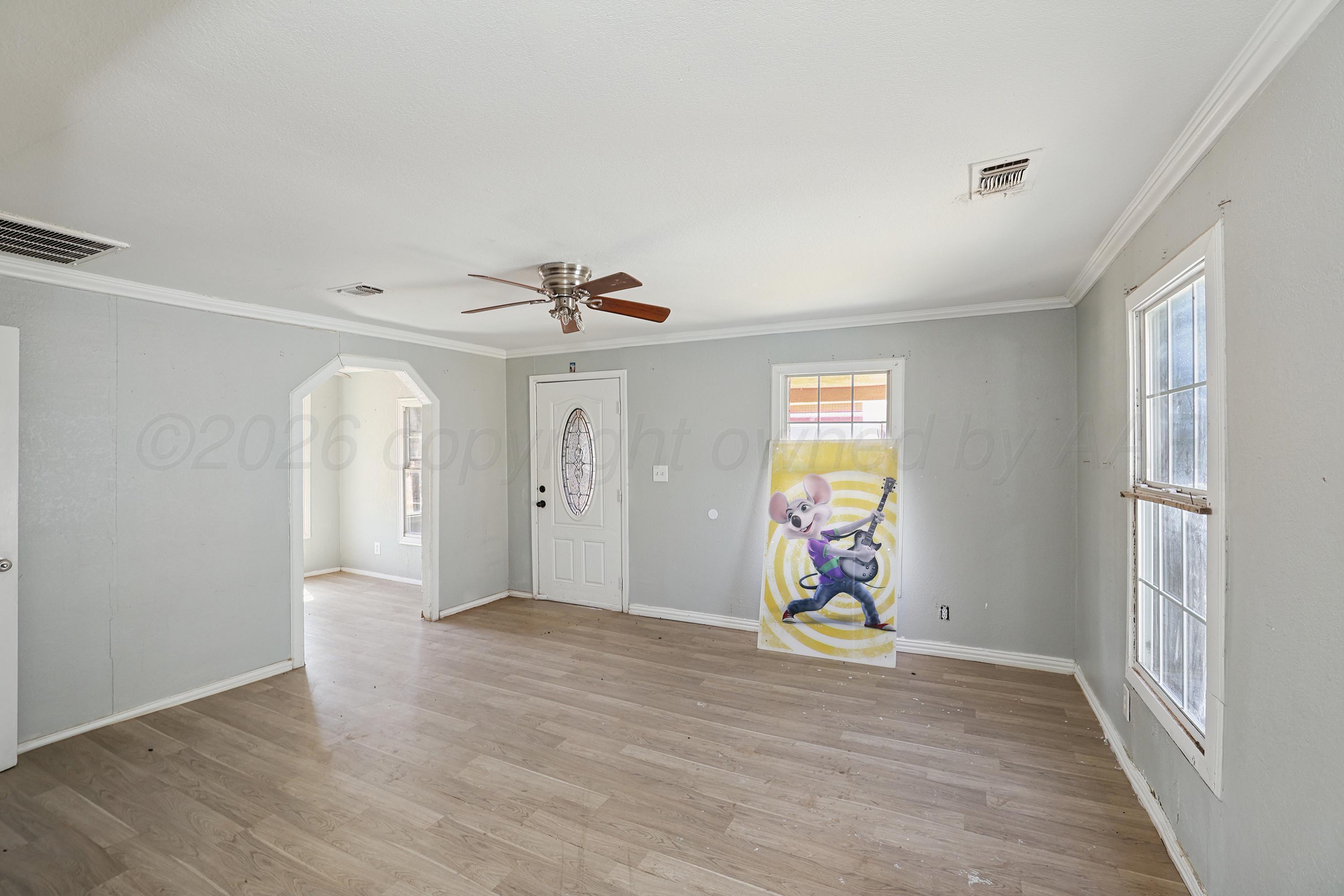 730 North Johnson Street Amarillo, TX 79107 - Photo 3 of 27 a view of an empty room with window and wooden floor