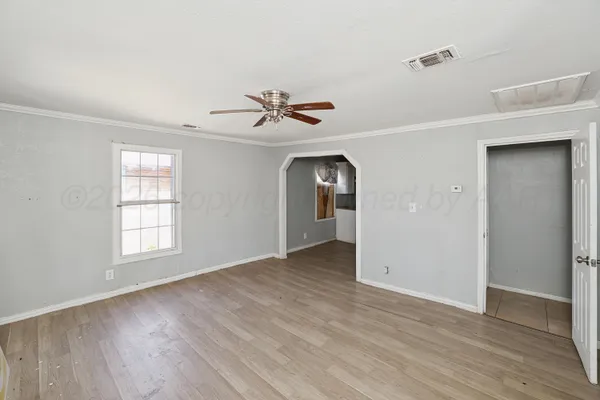 wooden floor in an empty room with a window