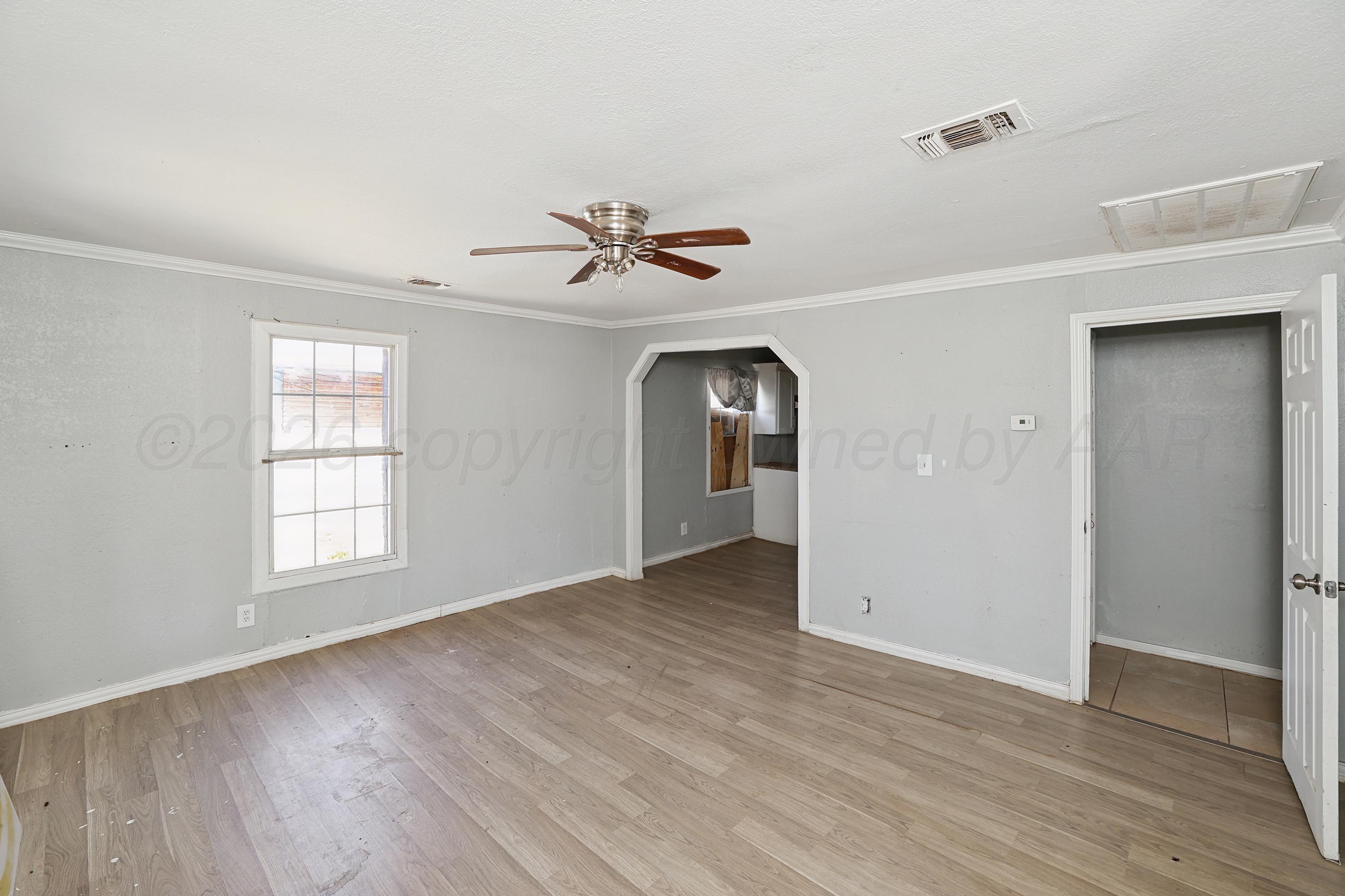730 North Johnson Street Amarillo, TX 79107 - Photo 4 of 27 wooden floor in an empty room with a window