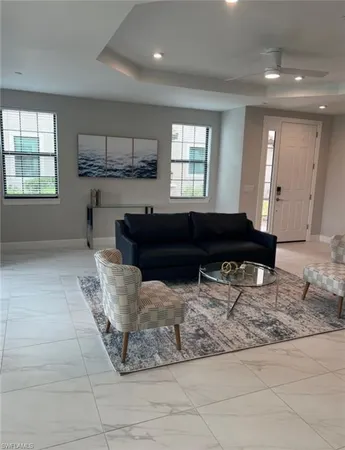 a living room with granite countertop furniture and kitchen view