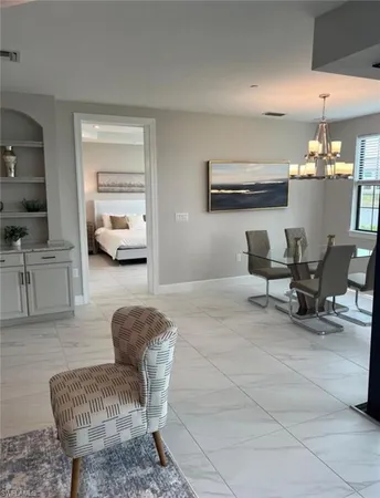 a dining room with furniture and window