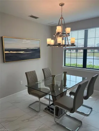 a dining room with furniture and window