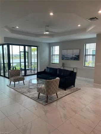 a living room with couches and a dining table with kitchen view