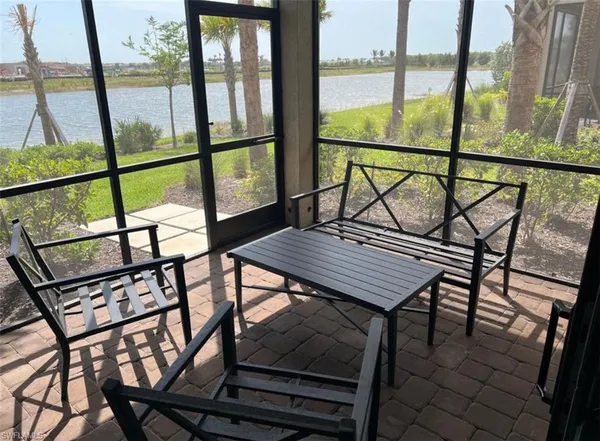 a view of a porch with wooden floor and a yard