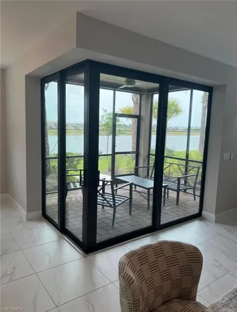 a living room with a large window and furniture