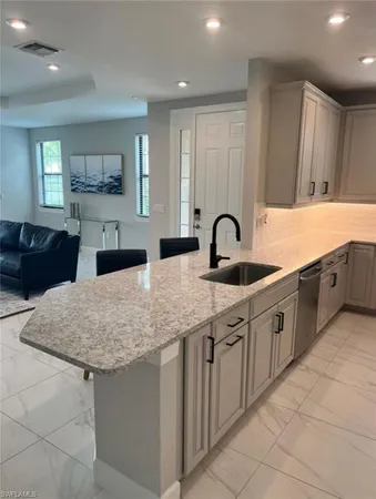 a kitchen with sink and cabinets