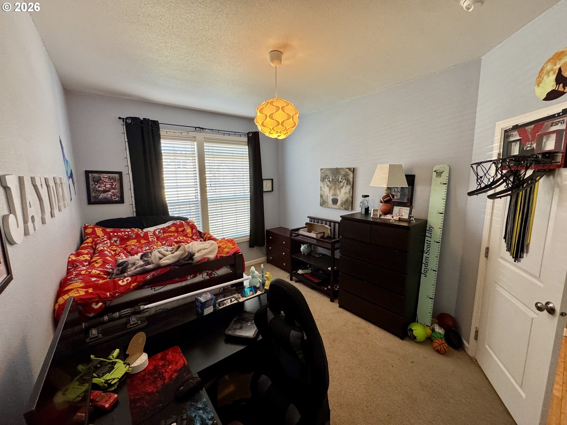 1105 G Street Baker City, OR 97814 - Photo 17 of 33 a bedroom with a bed closet and flat tv screen