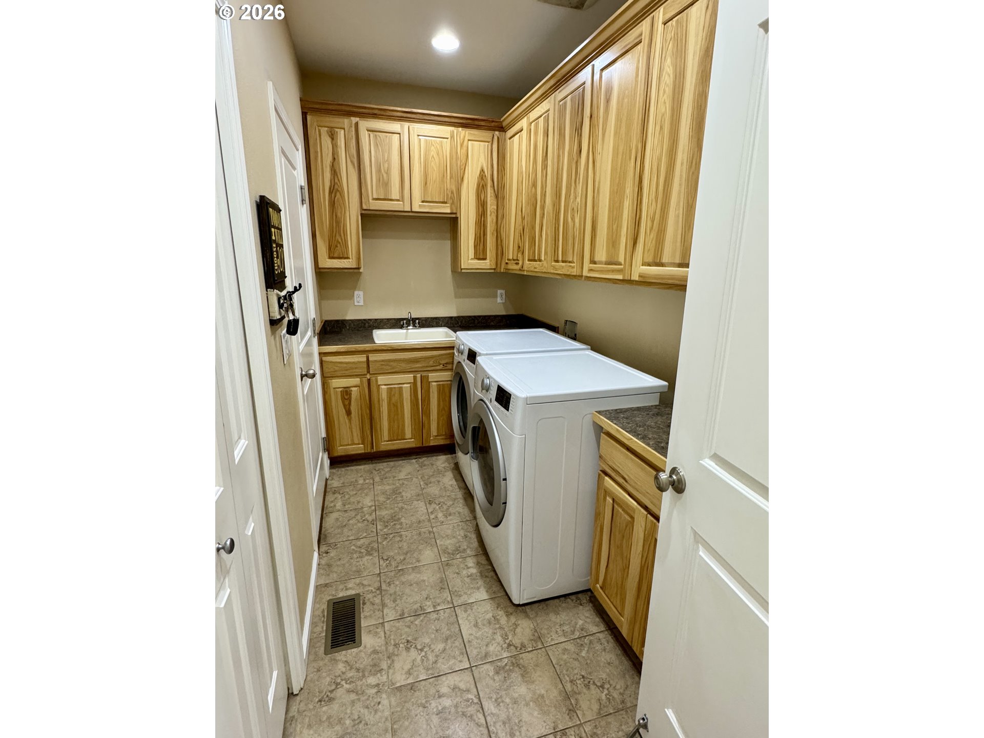 1105 G Street Baker City, OR 97814 - Photo 18 of 33 a utility room with a sink a washer and dryer