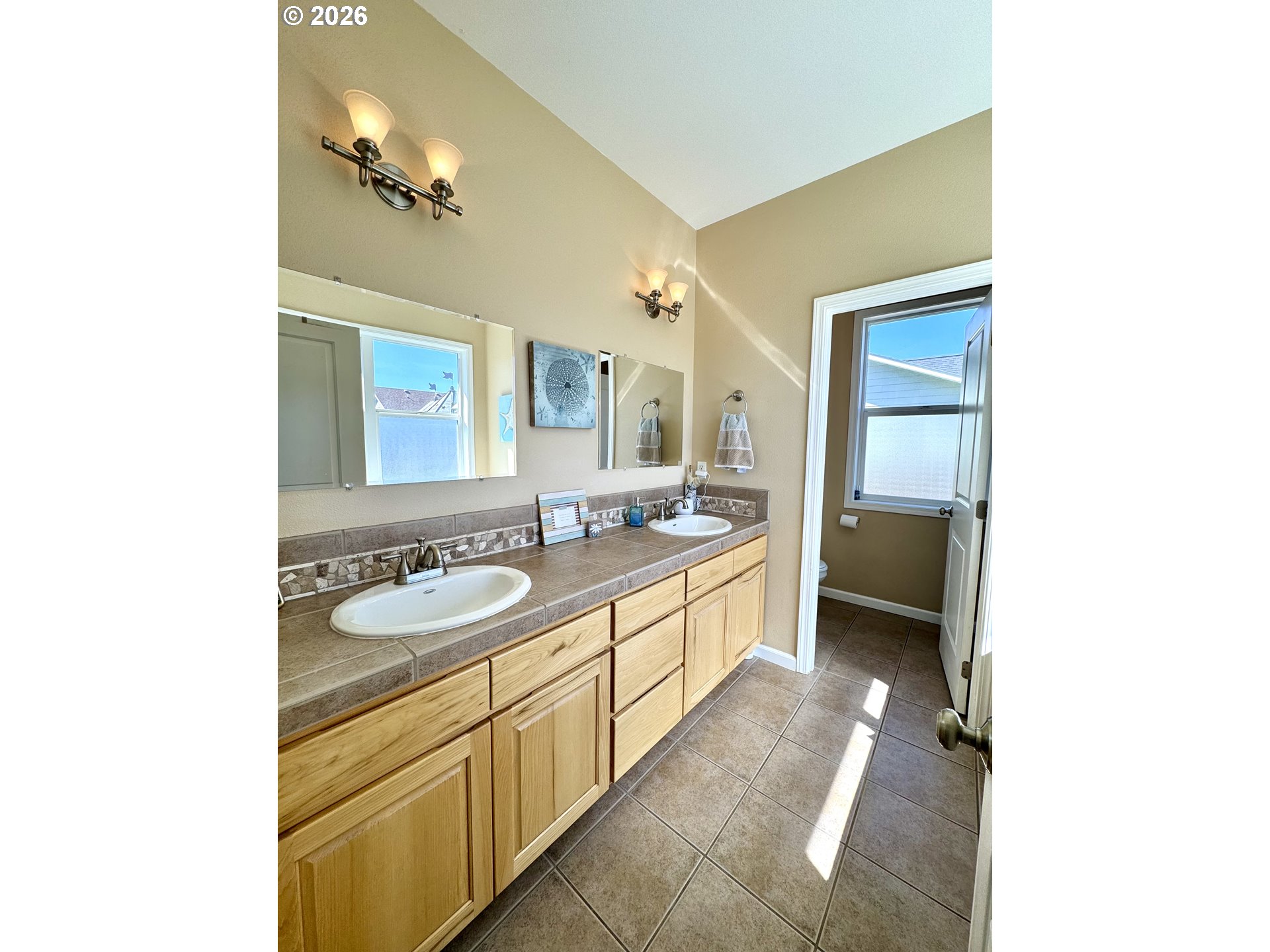 1105 G Street Baker City, OR 97814 - Photo 22 of 33 a spacious bathroom with a double vanity sink and a mirror
