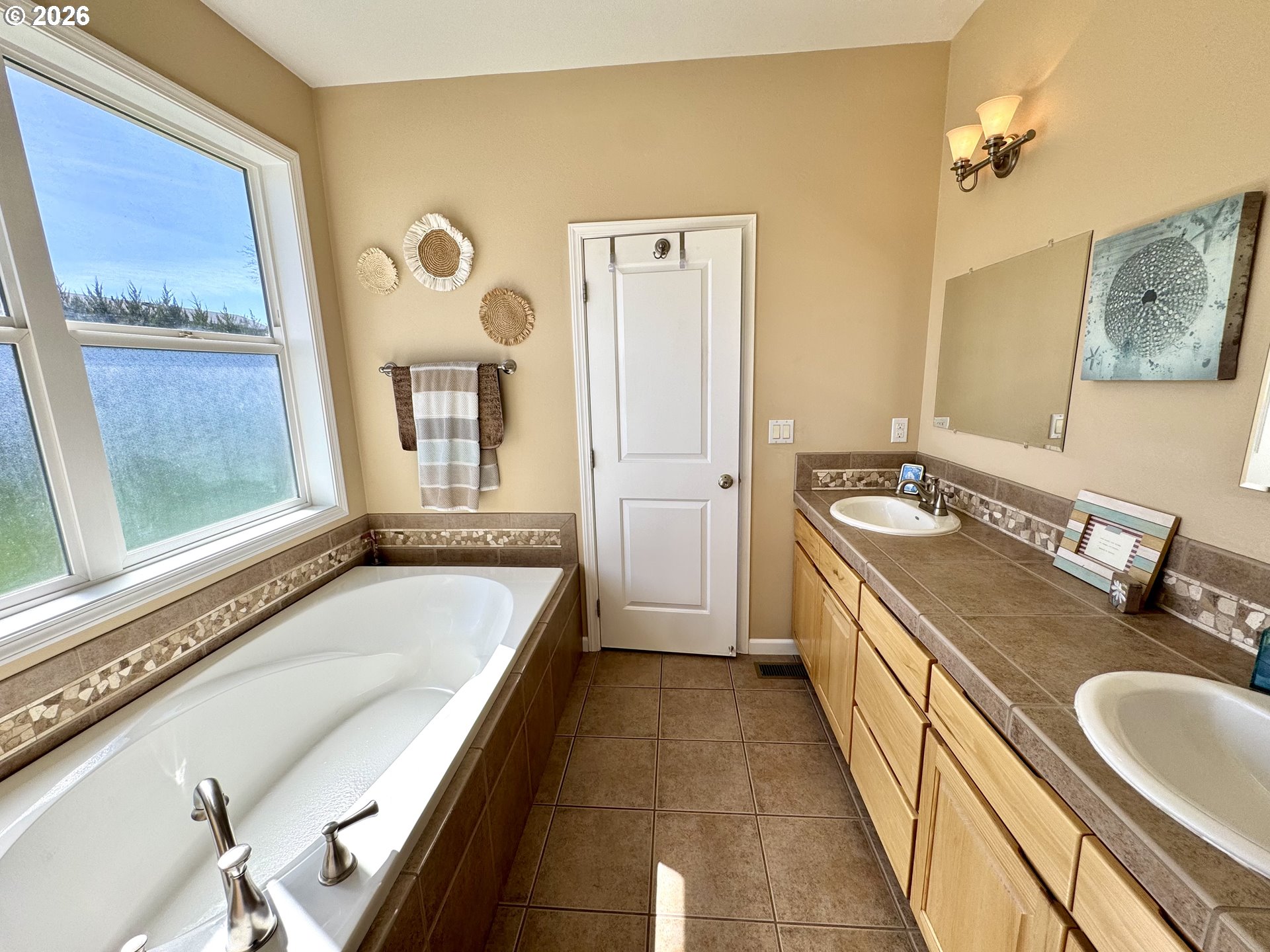 1105 G Street Baker City, OR 97814 - Photo 23 of 33 a bathroom with a granite countertop tub sink and mirror