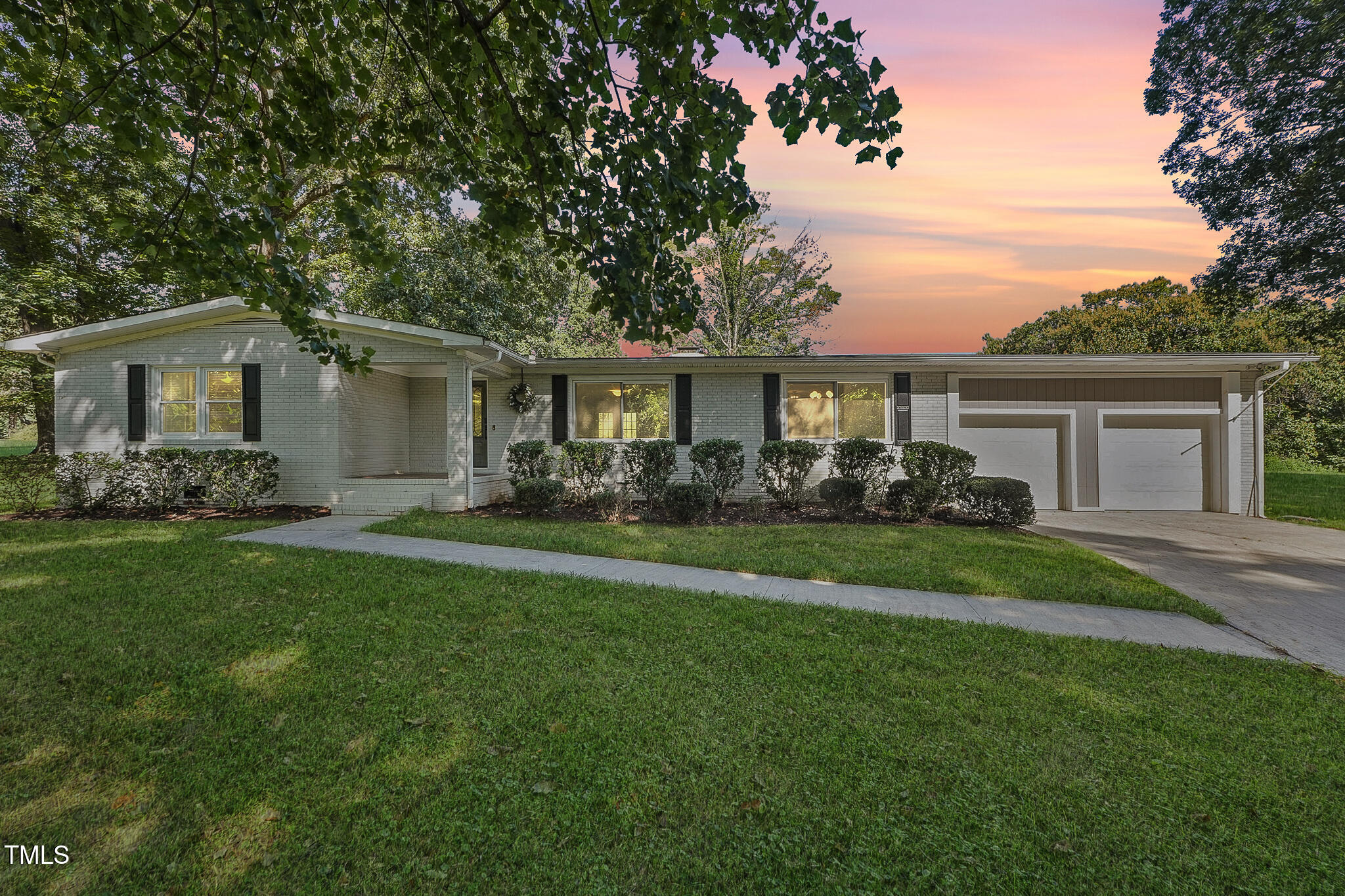 a front view of house with yard and green space