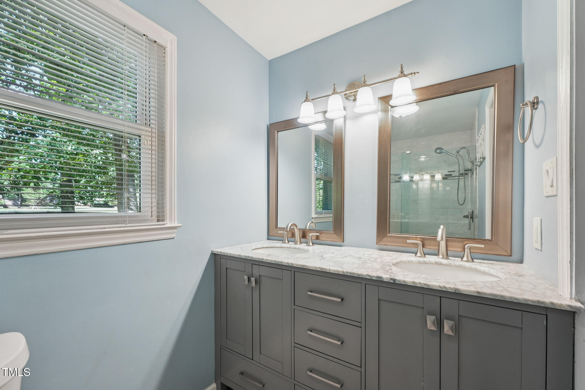 312 Mason Road Durham, NC 27712 - Photo 13 of 25 a bathroom with a double vanity sink and mirror with window